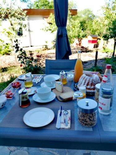 a blue table with plates of food and drinks on it at Aux vignes in Wissembourg