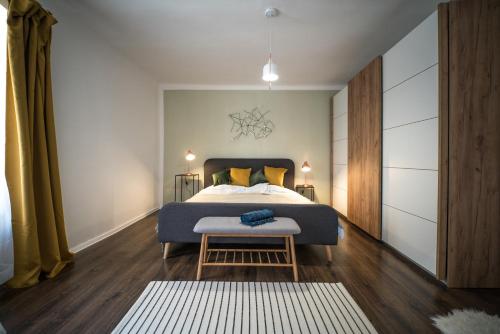 a bedroom with a king sized bed and a table at Presso Pécs in Pécs