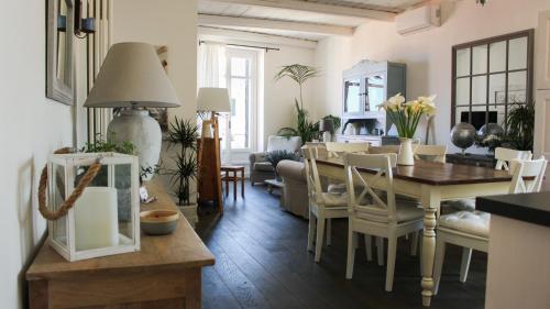 a dining room and living room with a table and chairs at Azzurro B&B in Cefalù