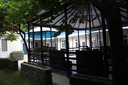 a gazebo with a pool in the background at Park Hostel Osh in Osh