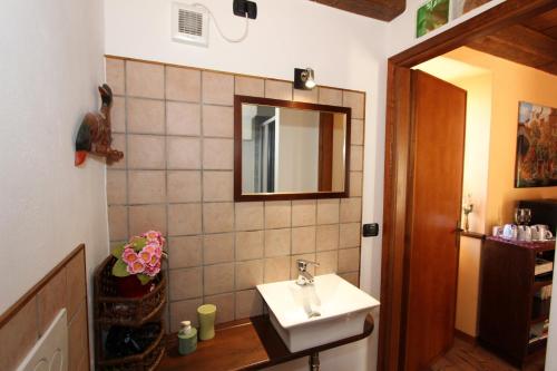 a bathroom with a sink and a mirror at B&B Il Castello Lago Maggiore con TERRAZZA in Cossogno