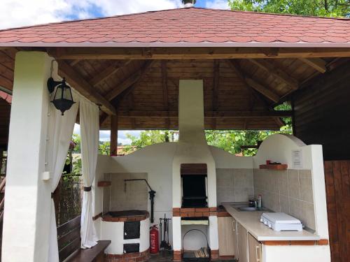an outdoor kitchen with a large stove top oven at Pensiunea Melinda in Praid