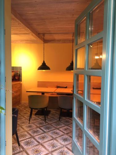 a dining room with a wooden table and chairs at Szent Anna Panzió in Esztergom