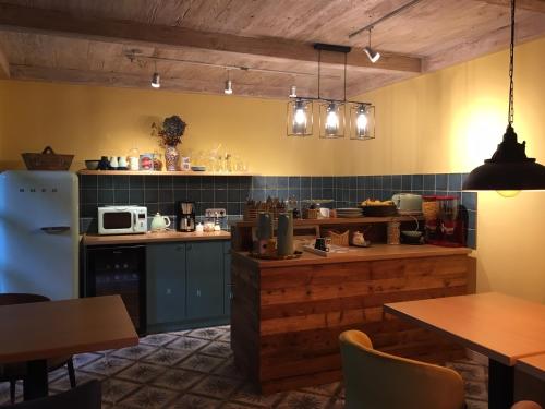 a kitchen with blue cabinets and a white refrigerator at Szent Anna Panzió in Esztergom