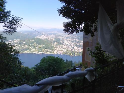 a view of a city and a lake from a fence at B&B Il Balcone sul Lago in Brunate
