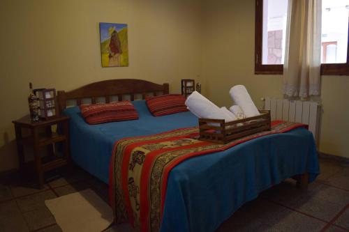 a bedroom with two beds with blue and red sheets at Azul Humahuaca Hostal in Humahuaca