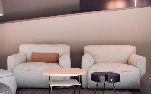 two chairs and a table in a room at Fritz Lauterbad in Freudenstadt