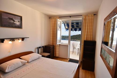 a bedroom with a bed and a view of the ocean at Dubrovnik Apartment Vista Mar in Dubrovnik