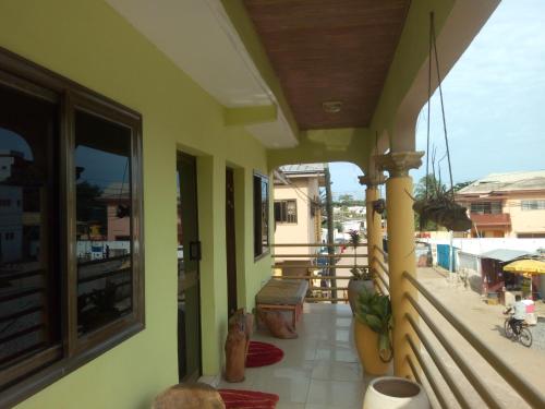 a porch of a house with a balcony at Feehi's Place in Accra