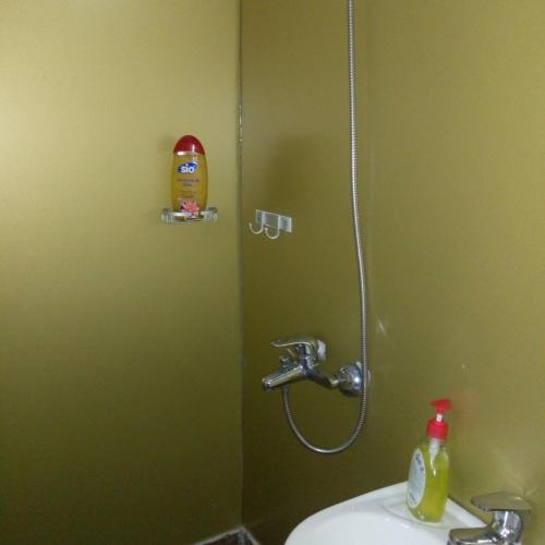 a bathroom with a shower with a sink and a sink at Feehi's Place in Accra