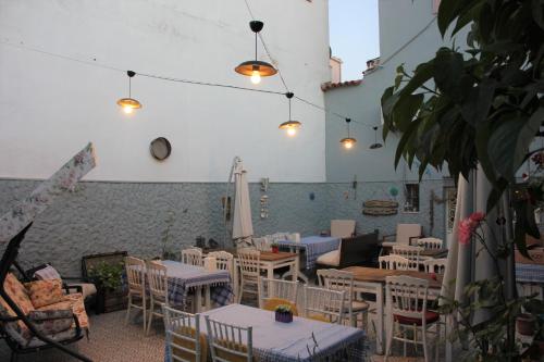 a restaurant with tables and chairs in a room at Macide Hanım Konağı in Ayvalık