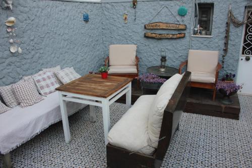 a bedroom with a bed and two chairs and a table at Macide Hanım Konağı in Ayvalık