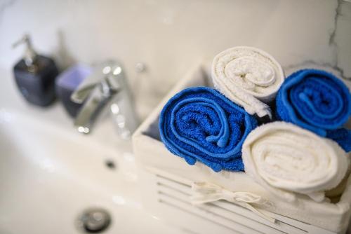 two blue and white towels sitting on a bathroom sink at California Apartments 3 in Dubrovnik