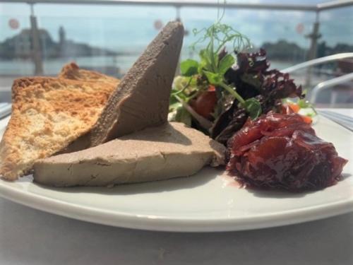 a plate of food with bread and a salad at The Harbour House Sea front Hotel in Portpatrick