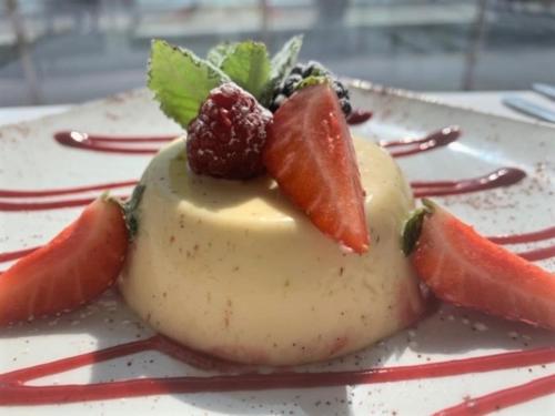 a plate with a dessert with fruit on it at The Harbour House Sea front Hotel in Portpatrick
