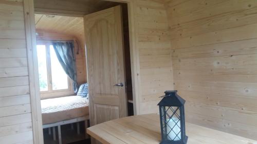 a room with a room with a bed and a window at Gaišie in Jūrmalciems
