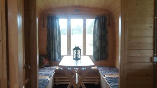a small table in a room with a window at Gaišie in Jūrmalciems