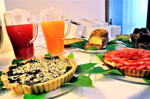 a table topped with different types of food and drinks at Hotel Liu in Lido di Camaiore