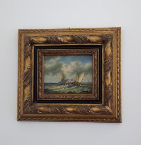 a framed painting of a sailboat in the ocean at Elegant and Sea View Excelsior Apartment in Levanto