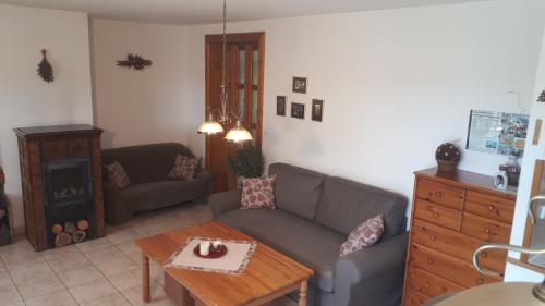 a living room with a couch and a table at Chalupa Ivana Bozkov in Bozkov