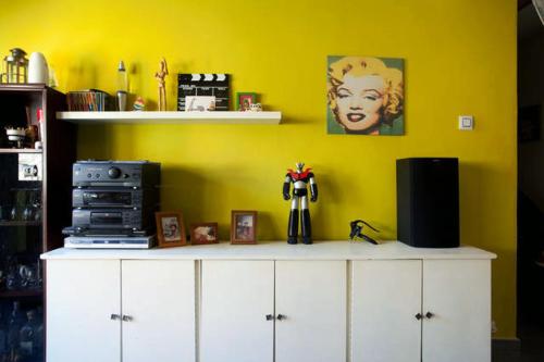 a room with a yellow wall and a white cabinet at Habitacion junto Torres Serranos in Valencia