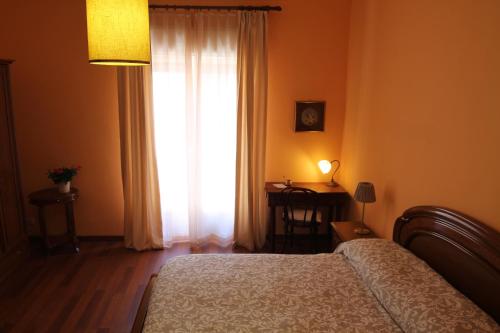Postel nebo postele na pokoji v ubytování B&B Torre Castellina