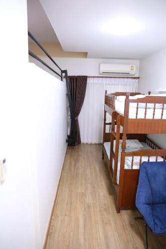 a room with two bunk beds and a ceiling at TD Bangkok in Bangkok