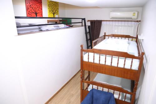 two bunk beds in a room with a wall at TD Bangkok in Bangkok