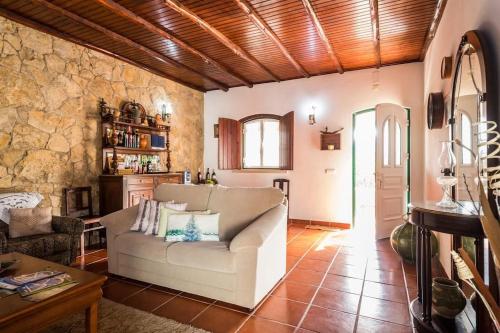 a living room with a couch and a table at Rustic Holiday House in the Natural Park in Alcobertas