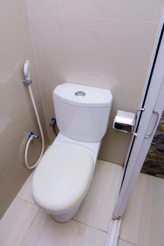 a bathroom with a white toilet in a stall at Homestay Garden Rest Kandy in Kandy