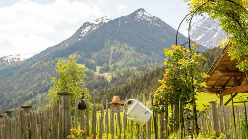 a wooden fence with a mountain in the background at Stubaier Bauern Appartement in Telfes im Stubai