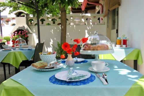 a table with a blue table cloth with food on it at B&B Vento del Mare in San Pietro in Bevagna
