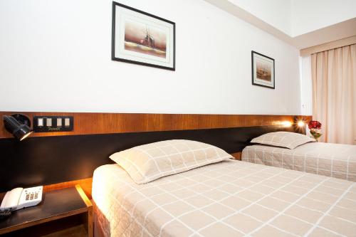 a hotel room with two beds and a telephone at Bahiamar Hotel in Salvador