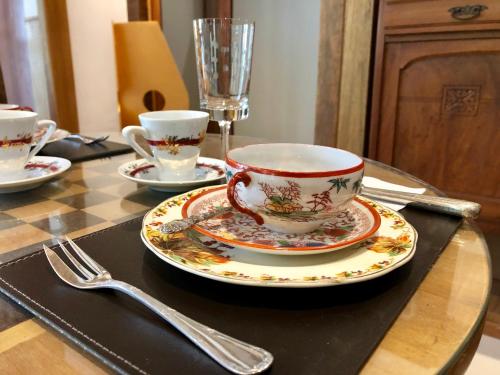 a tea cup and saucer on a table at Pousada Pataca de prata - Pousada de Época in Petrópolis