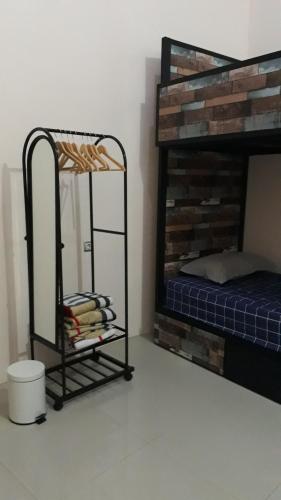 a bedroom with a bunk bed with a mirror at Omah Wilis in Batu