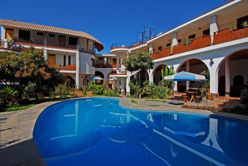 a swimming pool in front of a hotel at Hotel Alegria Nasca in Nazca