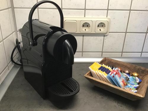 a coffee maker on a counter next to a box of toothpaste at Apartment 1 mit Terrasse und PKW-Stellplatz in Leverkusen