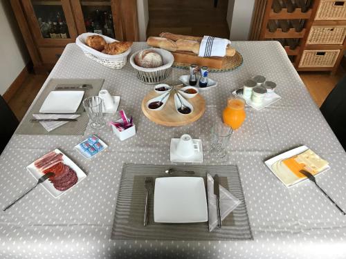 a table with food and drinks on top of it at Chambres Les Plantous de Severo in Cénac-et-Saint-Julien