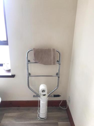 a towel rack in a bathroom with a toilet at Prime location rooms in high street in Fort William