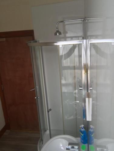 a bathroom with a shower and a toilet with a sink at Prime location rooms in high street in Fort William