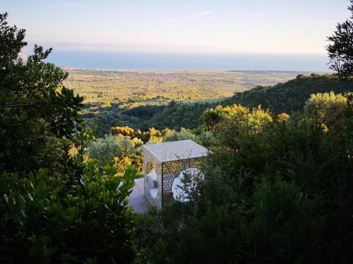 a building sitting on top of a hill with trees at Due Esperienza Panoramica in Lamezia Terme