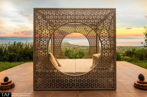 an arbor with a chair and a mirror at Due Esperienza Panoramica in Lamezia Terme