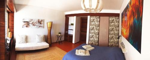 een woonkamer met een blauwe tafel en een bank bij Carcavelos Beach Studio in Lombos