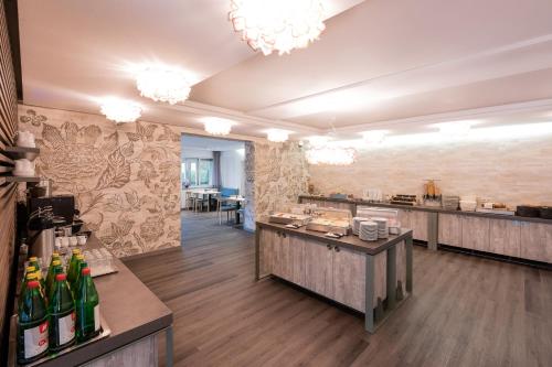 a restaurant with a bar with bottles of wine at Hotel Birkenhof in Bad Radkersburg