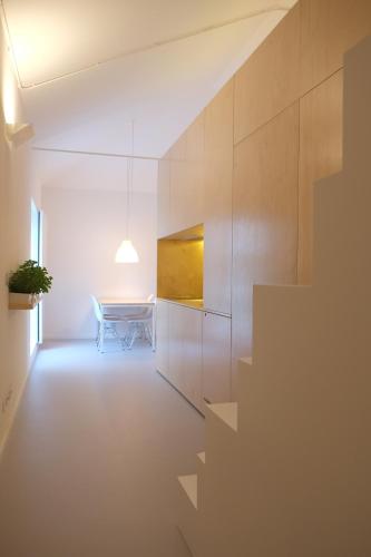 a dining room with a table and a staircase at Porto Serralves Designing Apartment in Porto