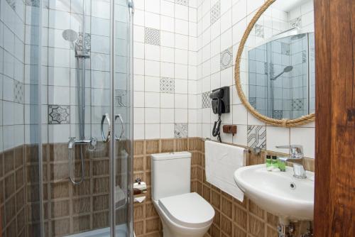 a bathroom with a toilet and a sink and a shower at Golden Fleece in Mtskheta