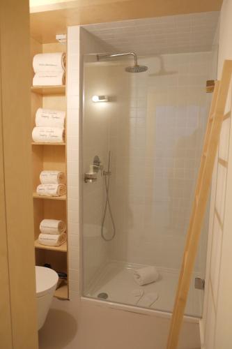 a bathroom with a shower with a toilet and towels at Porto Serralves Designing Apartment in Porto