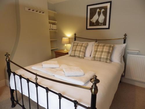 a bedroom with a bed with towels on it at Pond Farm in Pickering