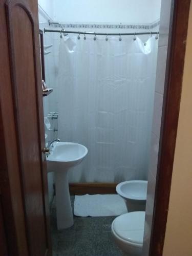 a bathroom with a toilet and a sink at Azul Humahuaca Hostal in Humahuaca