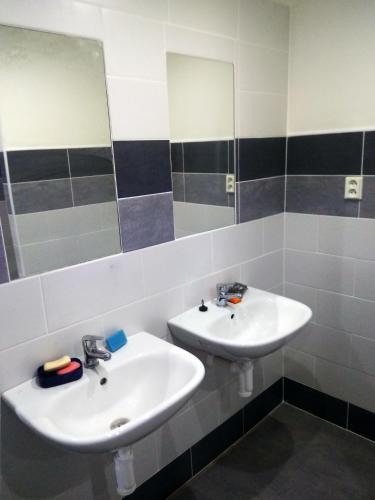 a bathroom with two sinks and a mirror at Apartmány U splavu in Veselí nad Moravou